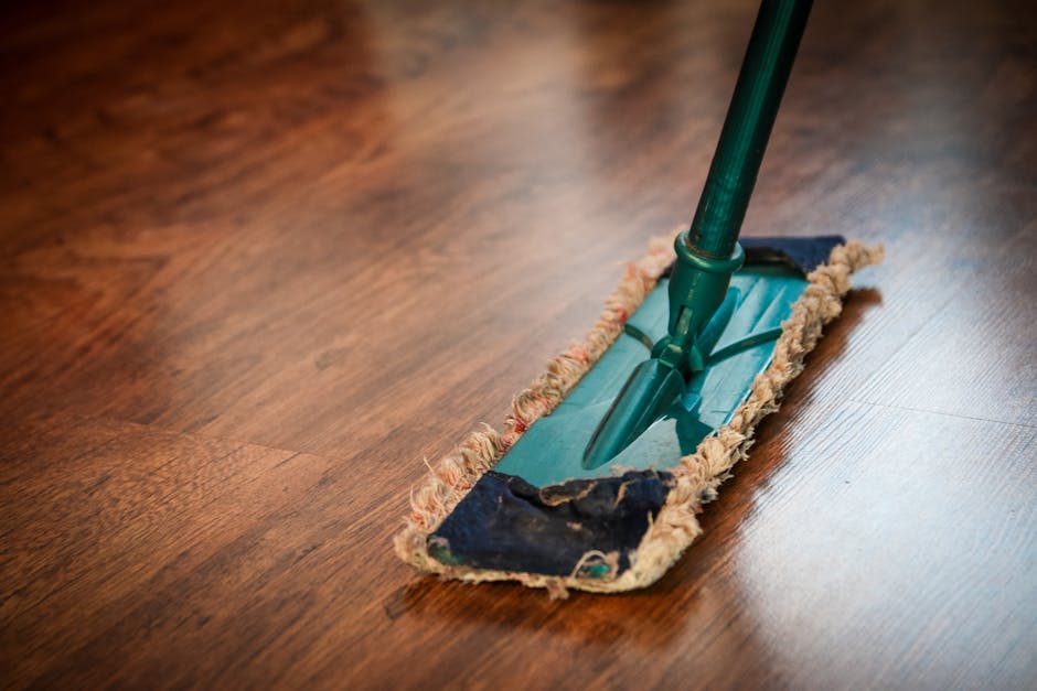 Home cleaning service in Alabama Home cleaning service in Alabama - A detailed view of a mop cleaning a wooden floor, showing texture and pattern.