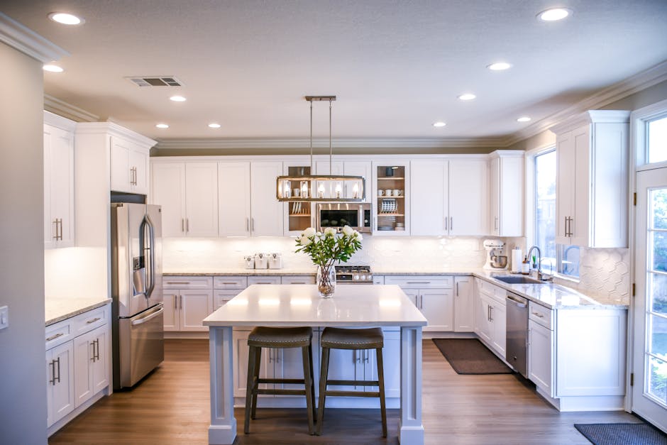 Kitchen Deep Cleaning Service in Lake Martin Alabama Spacious and elegant kitchen featuring white cabinetry, island, and stainless steel appliances.