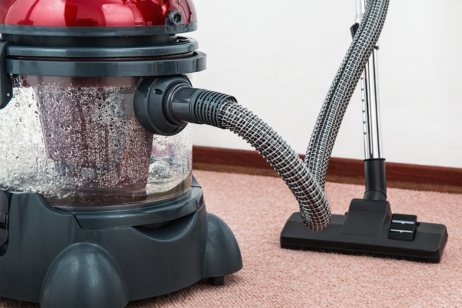vacuum-cleaner-carpet-cleaner-housework-housekeeping-38325-38325 Close-up of a modern vacuum cleaner with water filtration on carpet floor indoors.