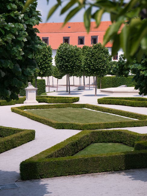 pexels-photo-12592146-12592146 A beautifully designed formal garden with neatly trimmed hedges and trees, embodying European elegance.