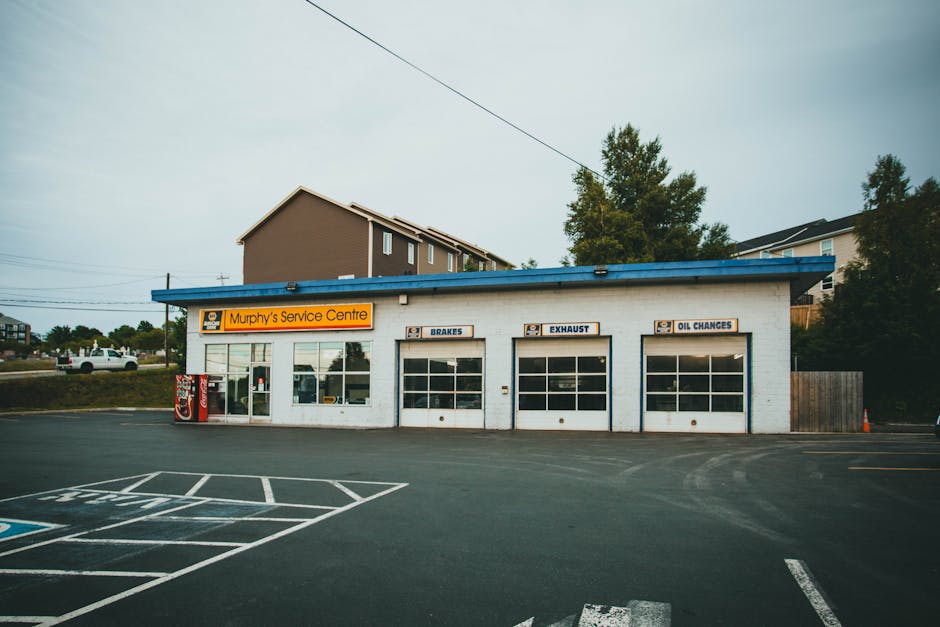 pexels-photo-8811451-8811451-1 Exterior view of Murphy's Service Centre, showcasing workshop and spacious parking area.